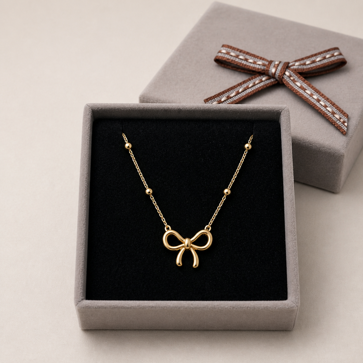 Anti-Tarnish Gold bow Pendant in a Grey Velvet Box gift box