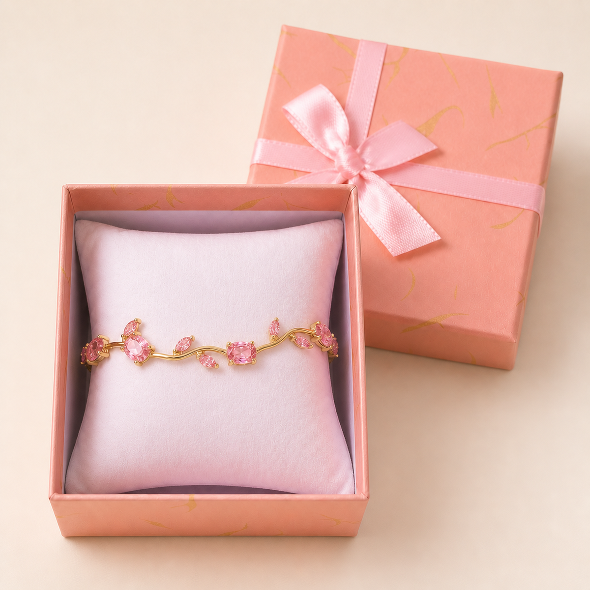 Tulip Bracelet (Pink) in an open blush-pink gift box — worn around the cushion