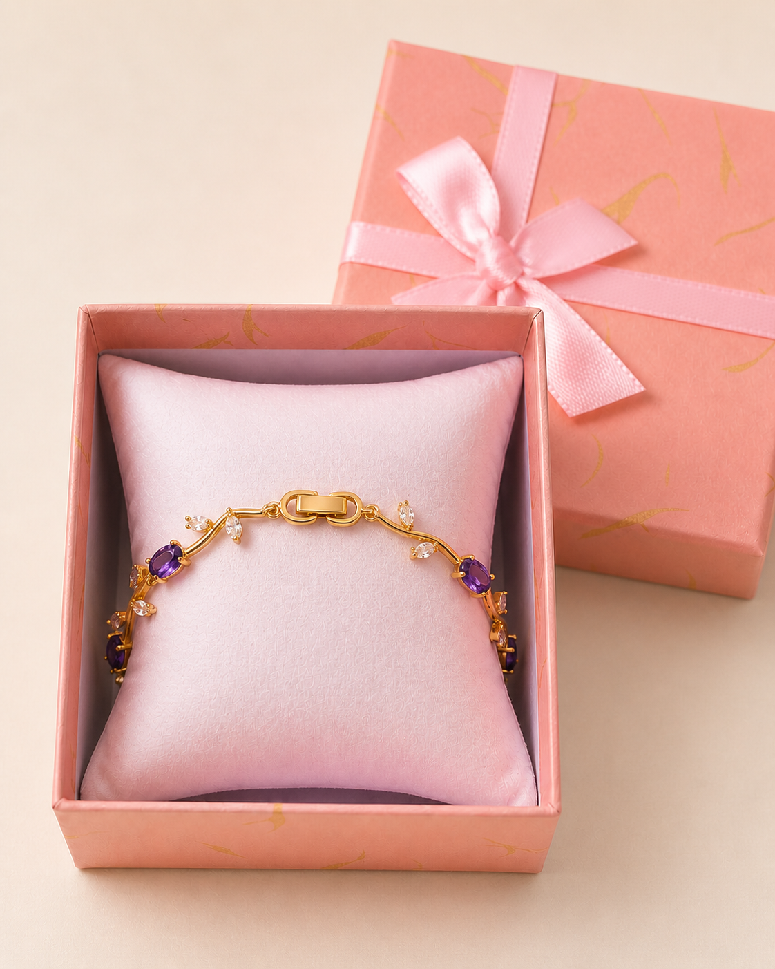 Tulip Bracelet (Purple) in an open blush-pink gift box — worn around the cushion
