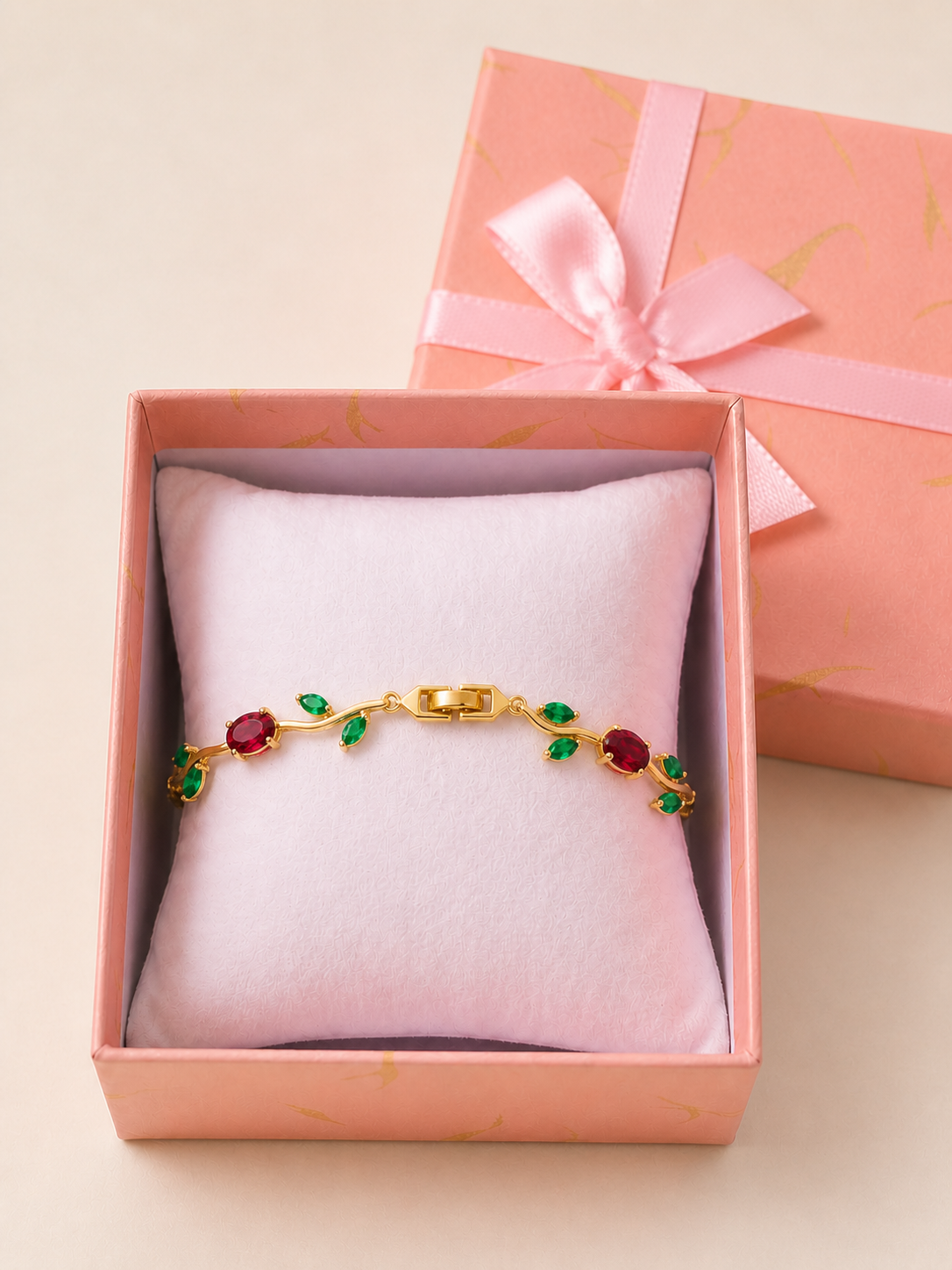 Tulip Bracelet (Red) in an open blush-pink gift box — worn around the cushion